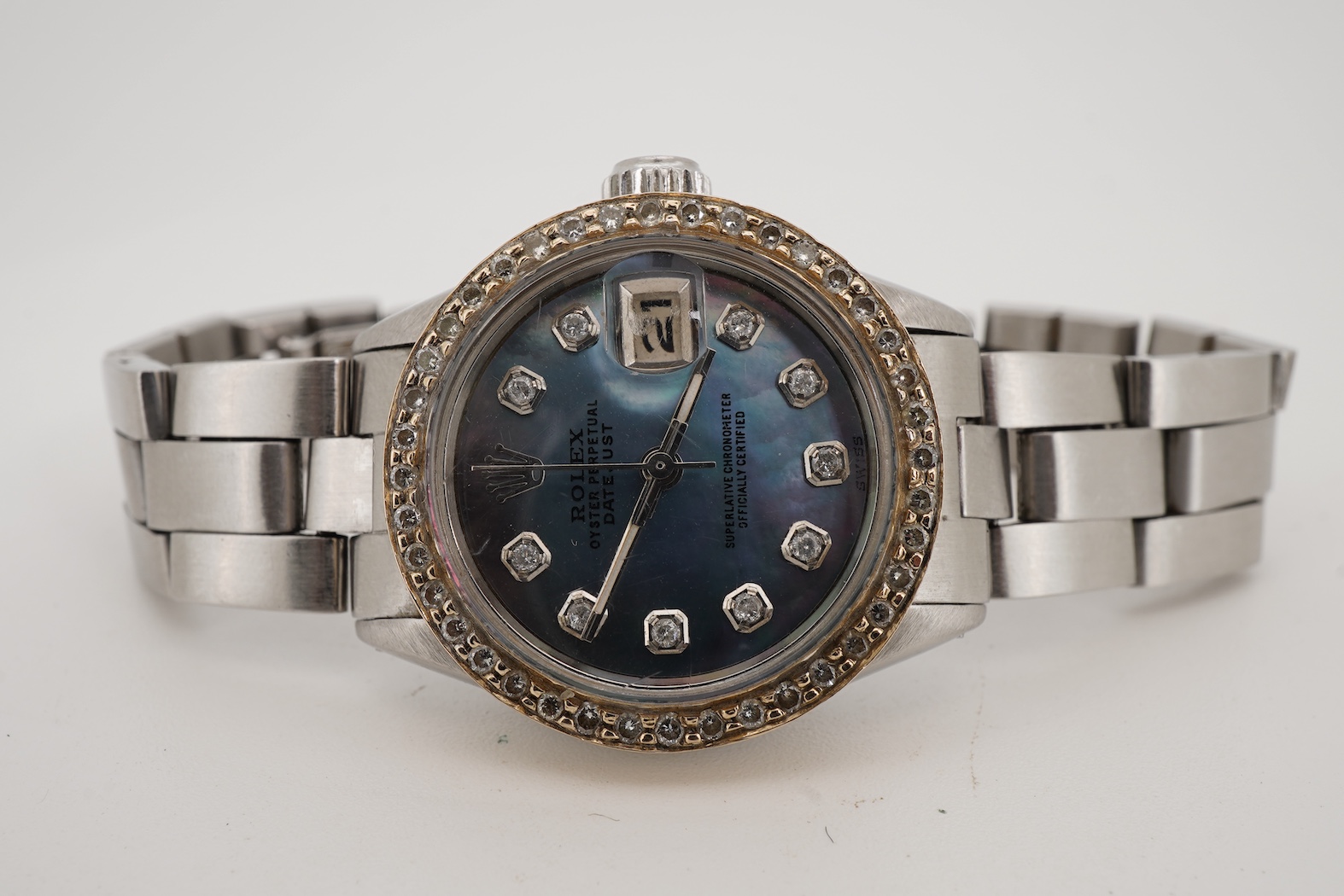 A lady's late 1960's stainless steel Rolex Oyster Perpetual Datejust, with later after market diamond set bezel and mother of pearl dial with diamond dot markers